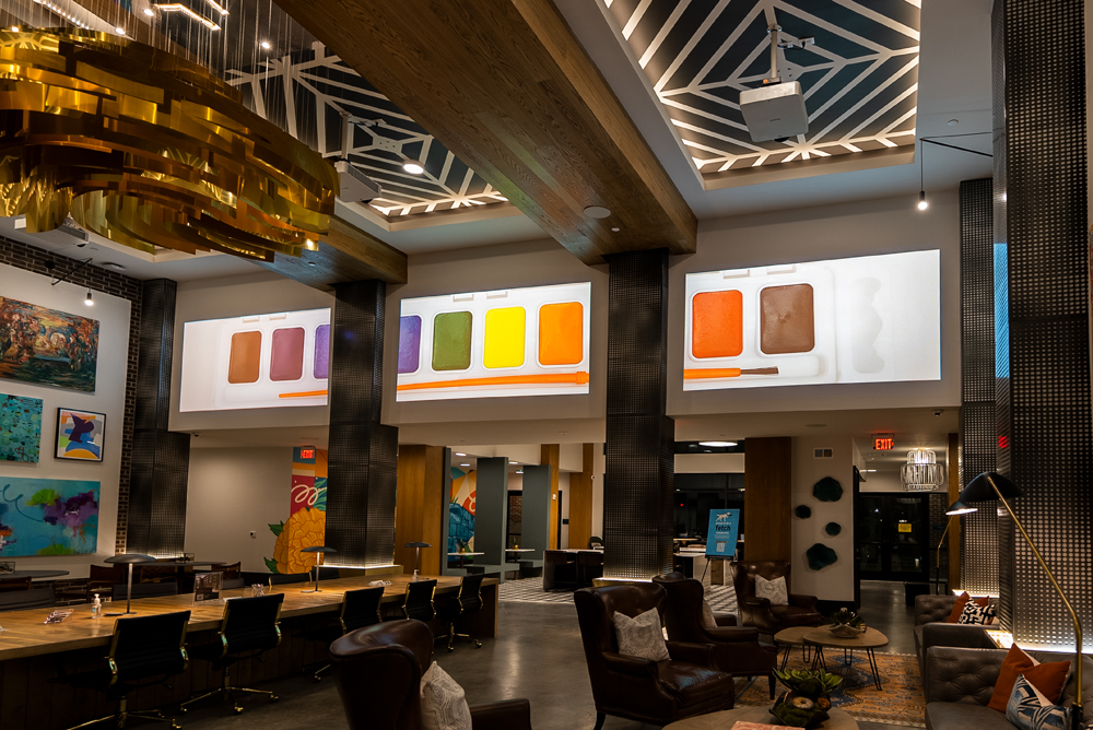 Screen on column in lobby showing water flowing over rocks